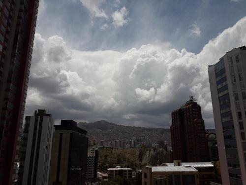 a view of a city with clouds in the sky at DEPARTAMENTO en La Paz MUNDO LUNA in La Paz