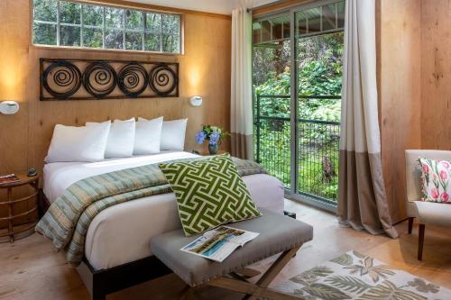 a bedroom with a bed and a window at Volcano Village Estates in Volcano