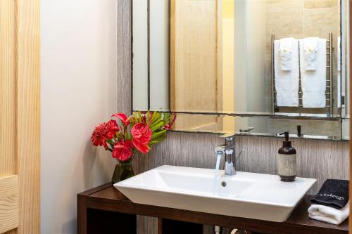 a bathroom with a sink and a mirror at Volcano Village Estates in Volcano