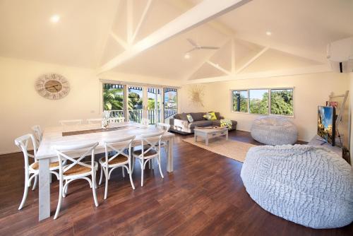 a dining room and living room with a table and chairs at Boathouse Resort Studios and Suites in Blairgowrie