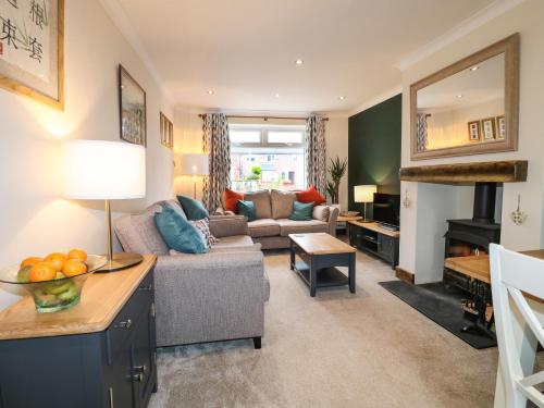 a living room with a couch and a table at The Corner House in Uttoxeter