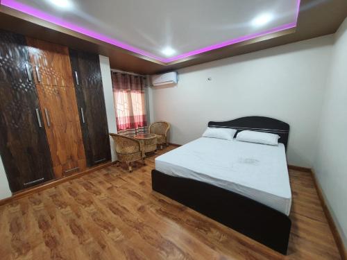 a bedroom with a bed in a room with wooden floors at Grace - Residential home in Kathmandu