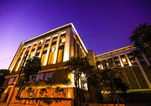 a large building with lights on in front of it at Radisson Bhopal in Bhopal