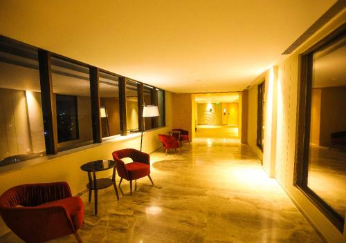a hallway with chairs and a table in a building at Radisson Bhopal in Bhopal