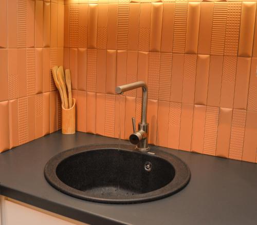 a sink with a faucet on top of a counter at Design Apartment near Gorica Park in Podgorica