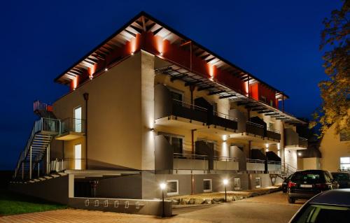 a building with cars parked in front of it at night at Bodensee-Hotel Sonnenhof in Kressbronn am Bodensee