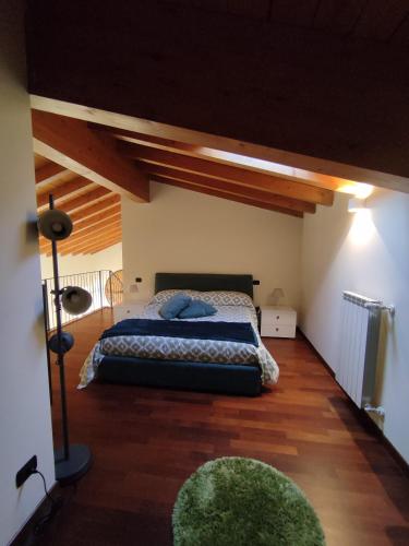 a bedroom with a bed in the middle of a room at La corte dell'orologio in Endine Gaiano