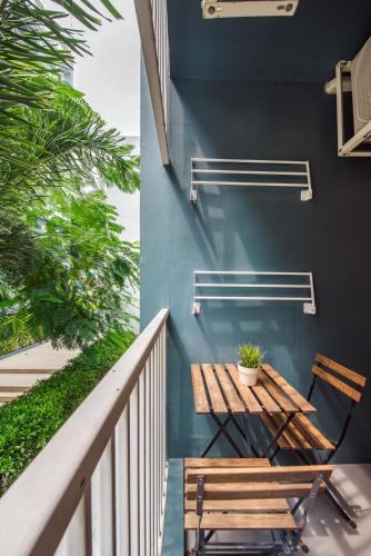 a wooden table and chairs on a balcony at Perfect Pool Apartment in Hua Hin