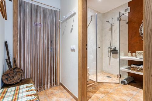 a bathroom with a shower and a glass shower stall at Sunset Room - Hiking & Beach in Odeceixe