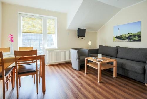 a living room with a couch and a table at Buedlfarm-SuedOst in Sahrensdorf