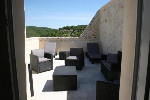 a group of chairs and tables on a patio at La Magnanerie de Fontfreyde in Gras