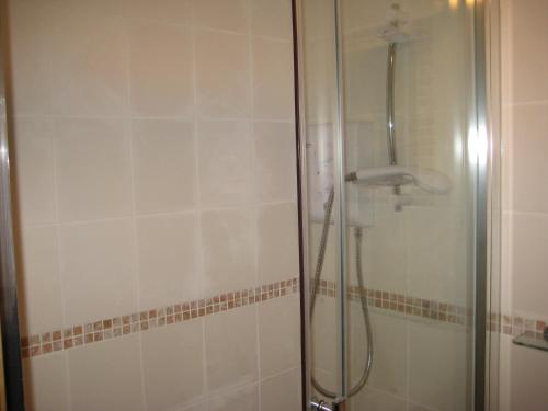 a bathroom with a shower with a glass door at Tanglewood Gatwick Bed & Breakfast in Crawley