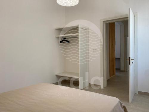 a white room with a bed and a closet at Villa Sebastia - 100m dalla spiaggia By Cala Salento in Torre Lapillo