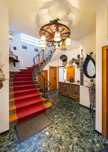 a staircase in a building with a red carpet at Aberseeblick Pension Ellmauer in St. Wolfgang