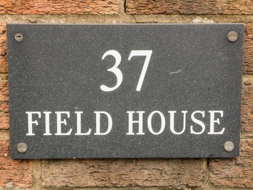 a sign for a field house on a brick wall at Field House in Alfreton