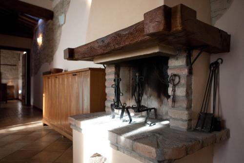 a kitchen with a brick fireplace in a room at Relais B&B Corte Dei Turchi in Longiano