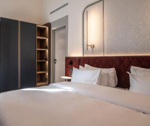 a bedroom with a large bed with white sheets and pillows at Luxury Apartments Palazzo Nani in Venice