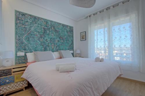sypialnia z dużym białym łóżkiem i dużym oknem w obiekcie 055 - Gran Playa Views - comfortHOLIDAYS w mieście Santa Pola
