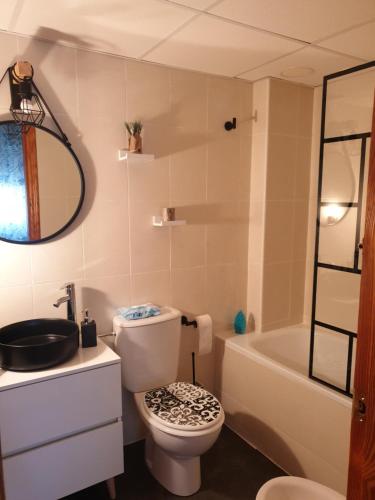 a bathroom with a toilet and a sink and a tub at La Union in Cuevas del Almanzora