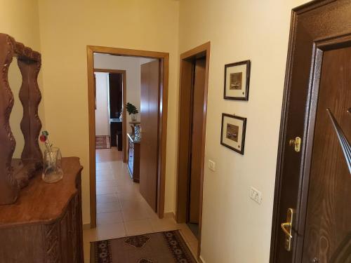 a hallway with a hallway leading to a room at Geni Apartment in Korçë