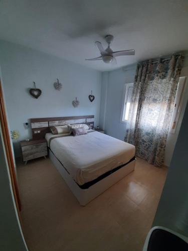 a bedroom with a bed and a ceiling fan at La Union in Cuevas del Almanzora