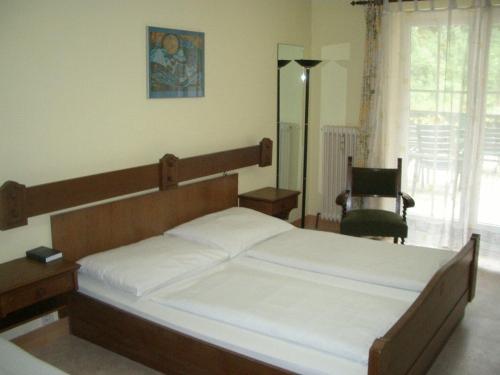 a bedroom with a bed and a chair in it at Torrenerhof in Golling an der Salzach