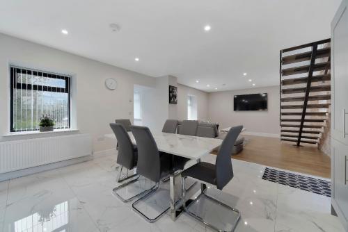 a dining room with a table and chairs at Glenside Abbey 'Sleeping 7 guests' in Buncrana
