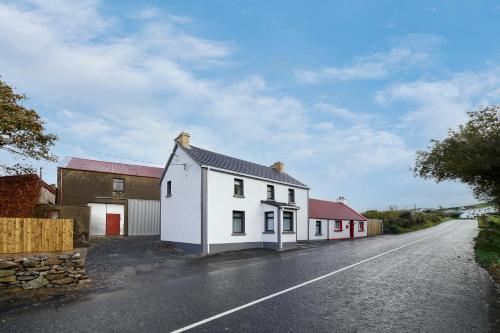 a white house on the side of a road at Glenside Abbey 'Sleeping 7 guests' in Buncrana