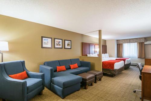 a hotel room with a couch and a bed at Comfort Suites Grayslake near Libertyville North in Grayslake