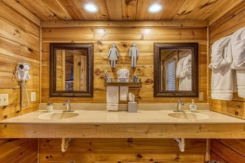 a bathroom with two sinks in a log cabin at Amazing Views, Pool, Hot Tub, Game Room in Sevierville