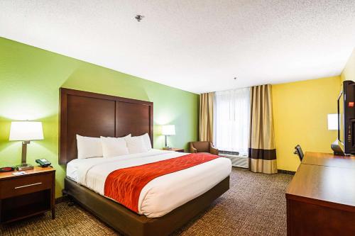 Habitación de hotel con cama y TV en Comfort Inn & Suites, en Dayton