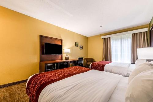 a hotel room with two beds and a flat screen tv at Comfort Inn & Suites Dayton Northwest - Englewood in Dayton