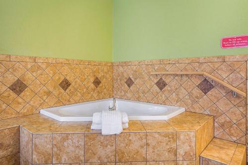 a bathroom with a tub with towels on it at Comfort Inn & Suites in Dayton