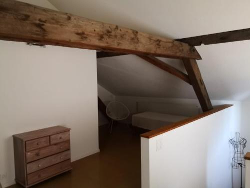 an attic room with a bed and a wooden ceiling at on a quiet location, beautiful, spacious holidayhouse, only for holidays, with a fantastic view, perfect for skiing, walking and hiking in Scheid