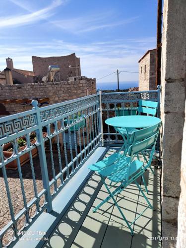 a blue table and chairs on a balcony at Petrounis Hotel in Areopolis