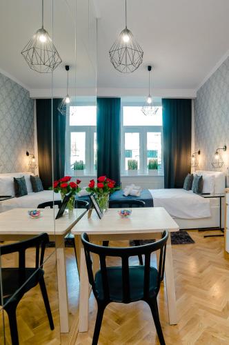 ein Wohnzimmer mit einem Tisch und 2 Stühlen in der Unterkunft Cracovia Wawel Apartments in Krakau