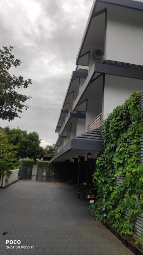 a building with a green hedge in front of it at Emperor-Hotel Rachana Continental Pvt Ltd in Kizhake Chālakudi