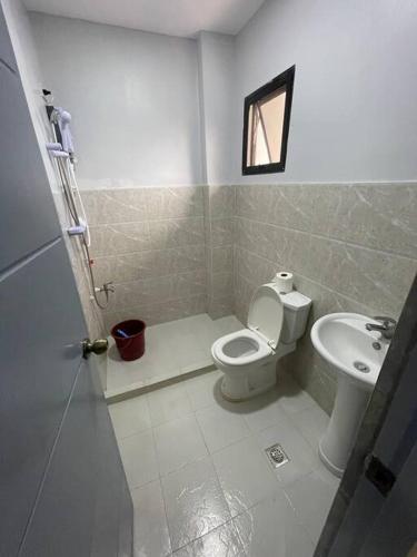 a bathroom with a toilet and a sink at Furnished apartment Daily rental in Mactan