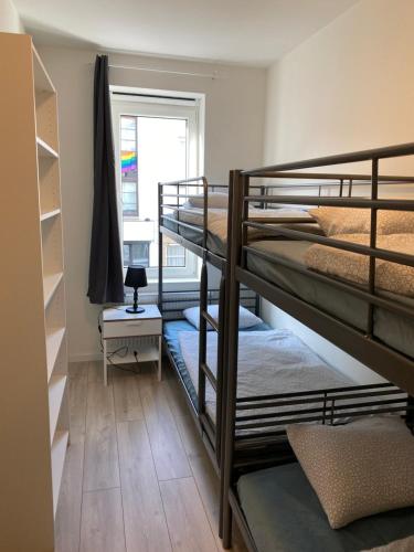 a room with three bunk beds and a window at Isabel Apartments in Antwerp