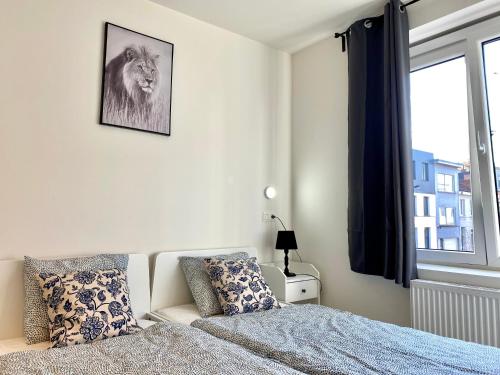 a bedroom with a bed and a window at Isabel Apartments in Antwerp