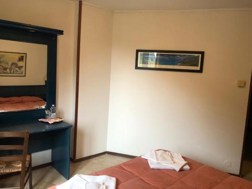 a bedroom with a bed and a desk and a window at petit paradis in Champorcher