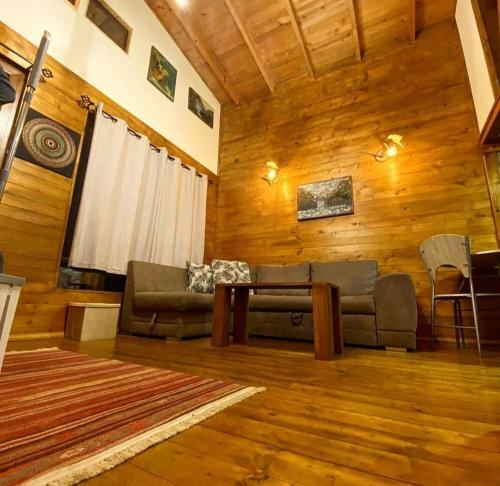 a living room with a couch and a table at Mavrovo Apartment in Mavrovo