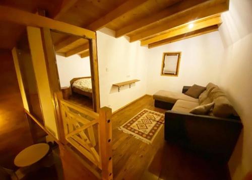 a living room with a couch and a bed at Mavrovo Apartment in Mavrovo