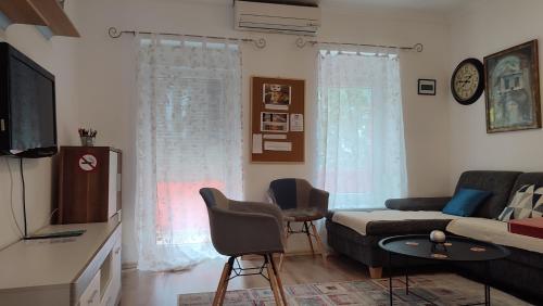 a living room with a couch and a tv at Apartment Mostar in Mostar