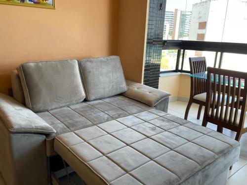 a leather couch in a living room with a window at MarAzul Residence in Salvador
