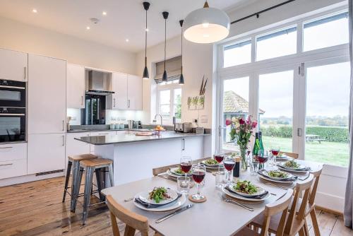 a kitchen with a table with glasses of wine at The Artist's House, Orford in Orford