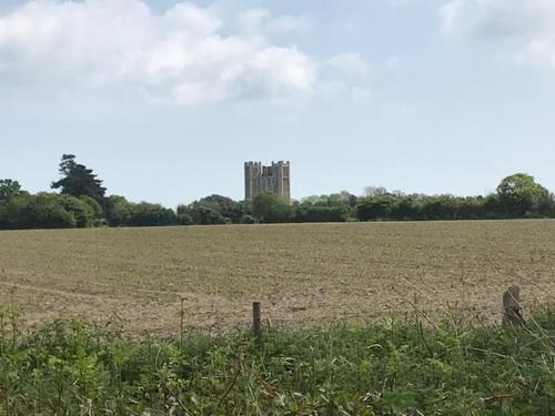 a large field with a castle in the distance at The Artist's House, Orford in Orford