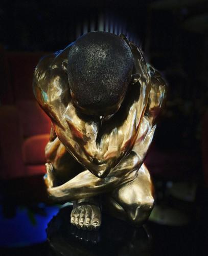 a statue of a turtle with a ball on its head at Grand Hôtel de Nîmes 4 étoiles in Nîmes