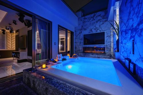 a large bath tub in a bathroom with a tv at HOTEL Dior7つくば in Tsuchiura