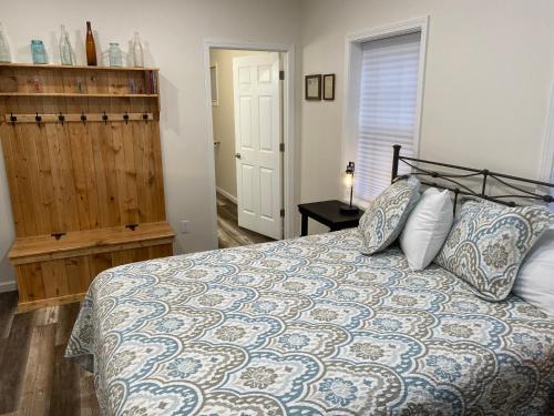 a bedroom with a bed with pillows on it at Hermann Crown Suites in Hermann